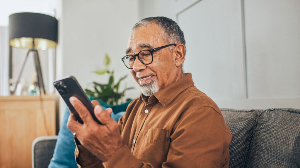 Straight Talk for Seniors: Plans and Pricing Portrait of cheerful senior man holding cell phone at home