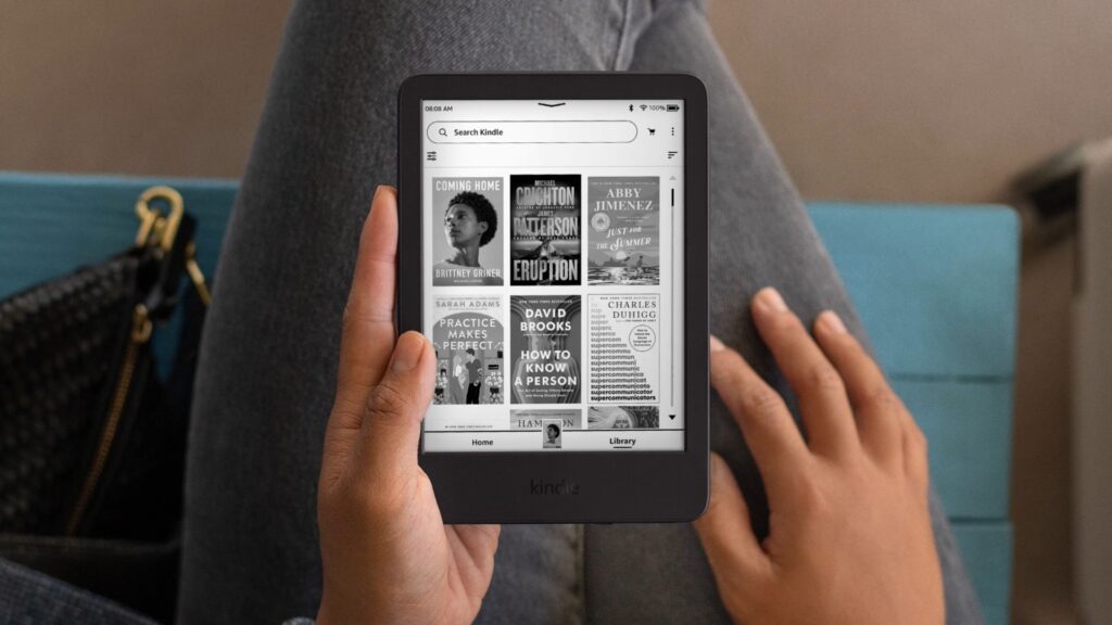 Did Your Kindle Get Bricked? Here Are the Best Prime Day Kindle Deals to Replace It A woman holding a Kindle in her lap while sitting in a chair.