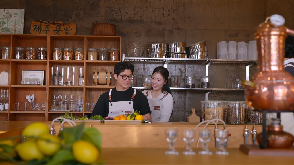 ‘Better Late Than Single’ Season 2 Reunion: What to Know A Korean man and woman wear aprons while standing behind a bar in a restaurant kitchen, in Netflix's Korean reality show 'Better Late Than Single' season 2.